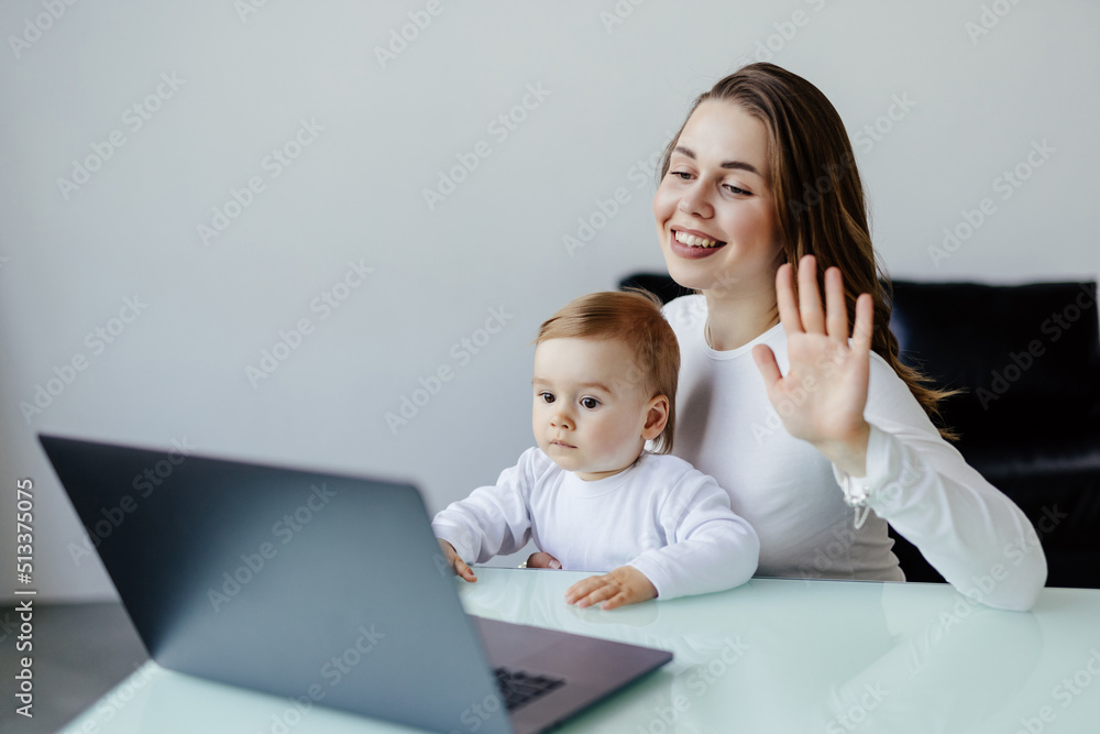 medicine, technology and healthcare concept. Happy mother with baby son having video chat with family doctor on laptop computer at home medicine, technology and healthcare concept. Happy mother with baby son having video chat with family doctor on laptop computer at home