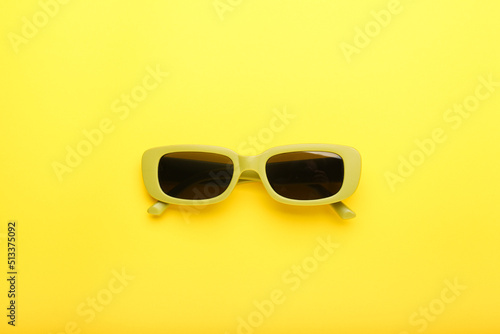 sunglasses on a yellow background, top view