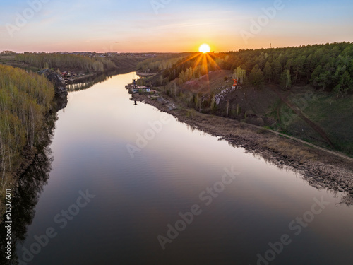 Beauriful sunset view along the Iset river and rocks near Kamensk-Uralskiy. A scenic sunset at the river. Kamensk-Uralskiy, Sverdlovsk region, Ural mountains, Russia. Aerial view photo