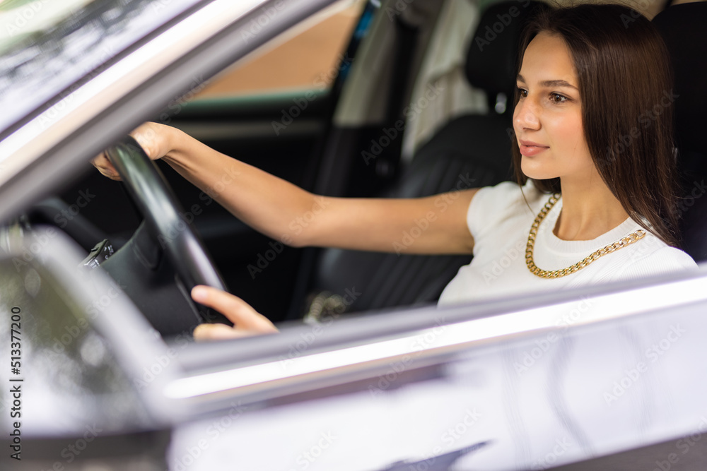 lifestyle and people concept. Happy smiling young woman or female driver driving car and drinking takeaway coffee lifestyle and people concept. Happy smiling young woman or female driver driving car and drinking takeaway coffee