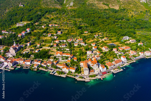 Montenegro. Adriatic Sea. Bay of Kotor. Popular tourist spot. Village on the coast. Houses with orange tiled roofs. Summer. Tourist season. Drone. Aerial view © Oleksandr Baranov