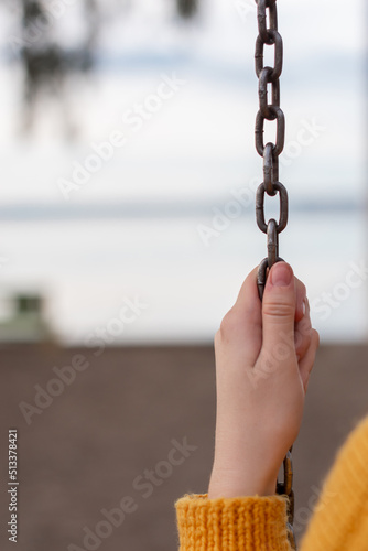 Girl hand holding steel chain