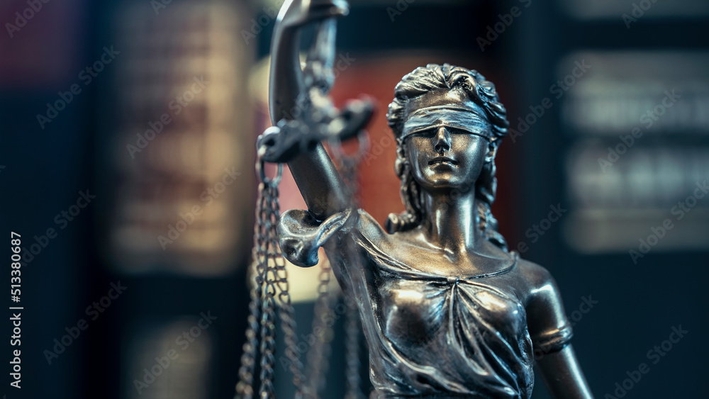 Legal and law concept statue of Lady Justice on books background