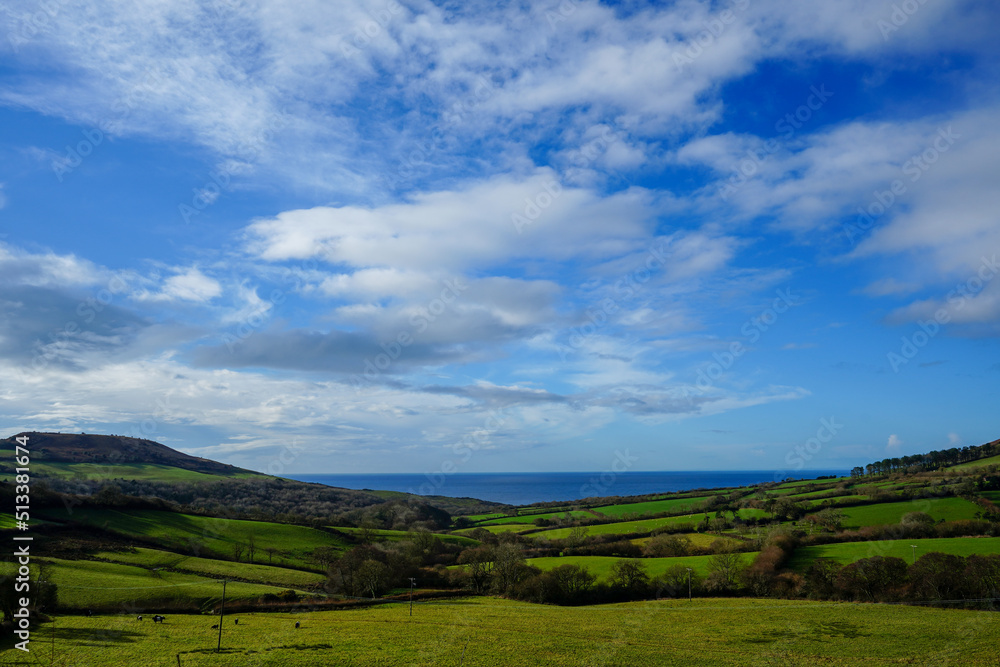 View over the countryside and ocean with blue skies