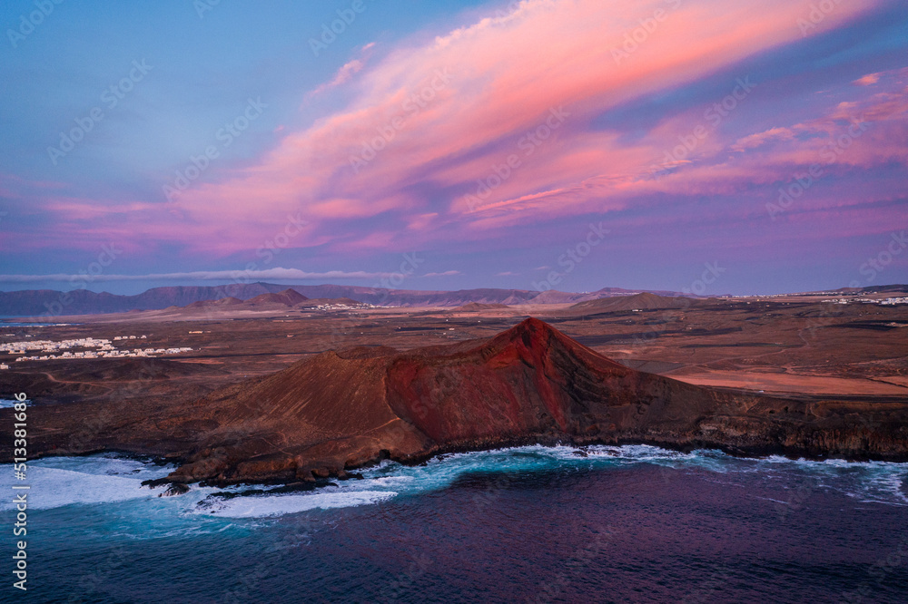 aerial view of volcano at coast during colorful sunset 