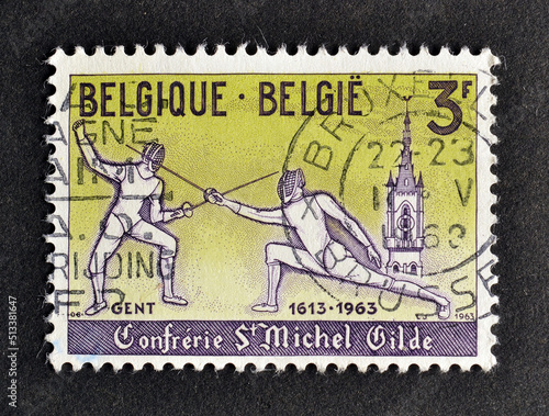 Cancelled postage stamp printed by Belgium, that shows Fencing, 350th Anniversary of Royal Guild and Knights of St Michael, circa 1963. photo