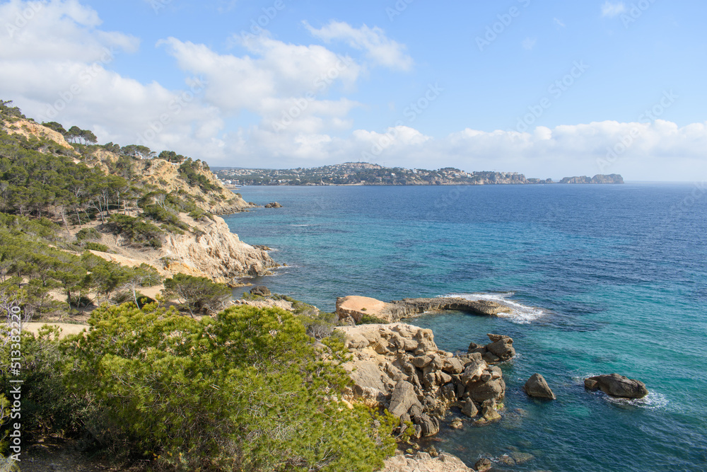Coastal cliffs and turquoise sea water in coastline of Peguera
