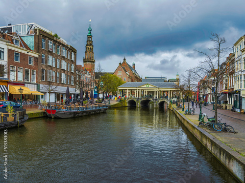 Traditional dutch buildings on the canal during a cloudy day in Leiden, Netherlands