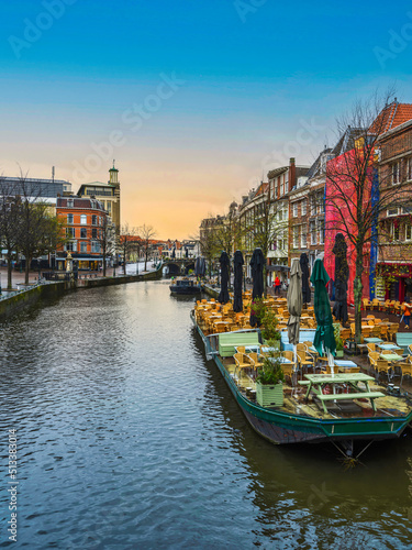 Boat restaurants and dutch buildings on the canal in Leiden, Netherlands