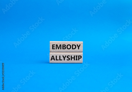 Embody Allyship symbol. Concept word Embody Allyship on wooden blocks. Beautiful blue background. Business and Embody Allyship concept. Copy space