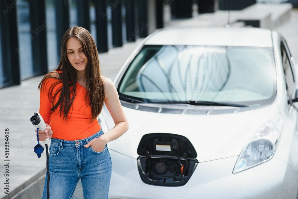 Woman is charging rental electric car