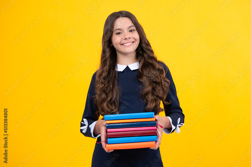 Teen girl pupil hold books, notebooks, isolated on yellow background, copy space. Back to school, teenage lifestyle, education and knowledge. Teen girl pupil hold books, notebooks, isolated on yellow background, copy space. Back to school, teenage lifestyle, education and knowledge.