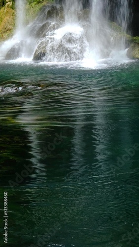 A vertical background photo with a waterfall