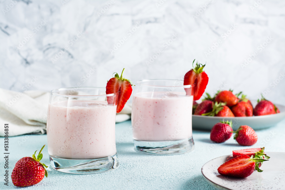 Milk smoothie with strawberries and mint in glasses on the table. Healthy homemade food Milk smoothie with strawberries and mint in glasses on the table. Healthy homemade food