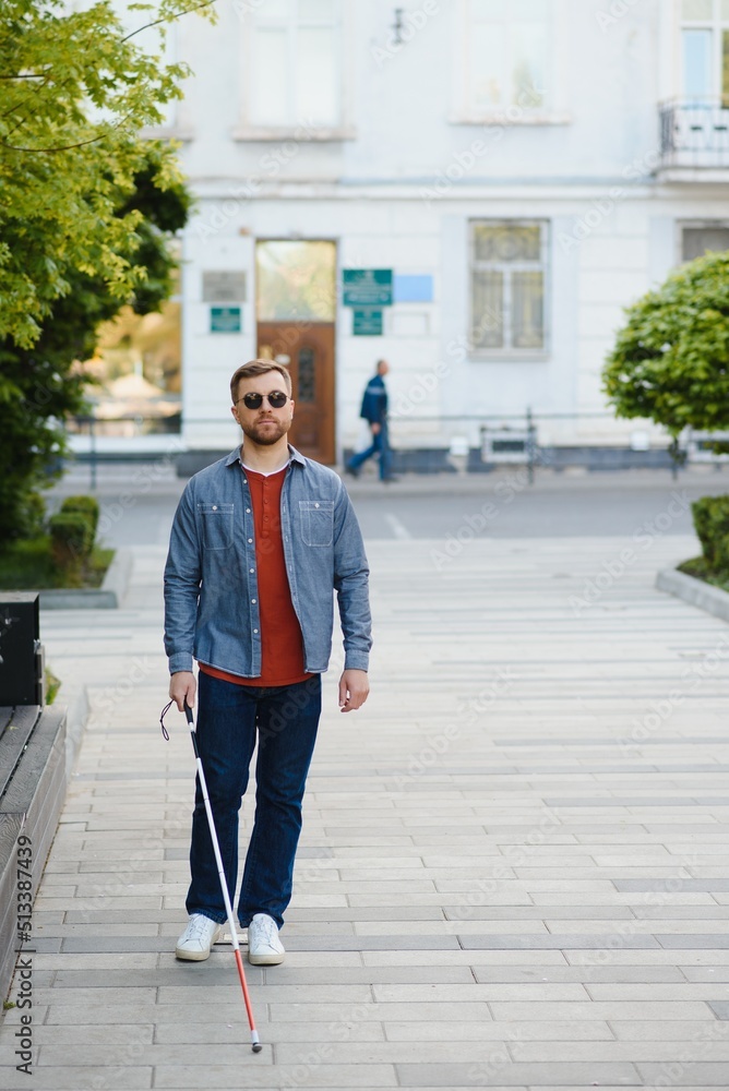 Blind man. People with disability, handicapped person and everyday life. Visually impaired man with walking stick. Blind man. People with disability, handicapped person and everyday life. Visually impaired man with walking stick.