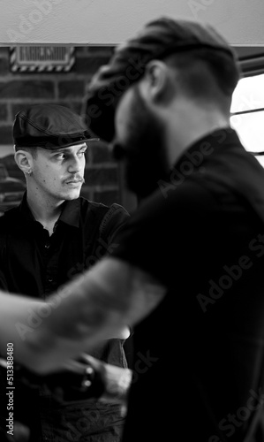 Barber shop, Model with cigar in hand inside a barber shop, Low key style, selective focus.