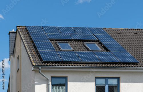 solar panels or photovoltaic power plant on a black tiled roof