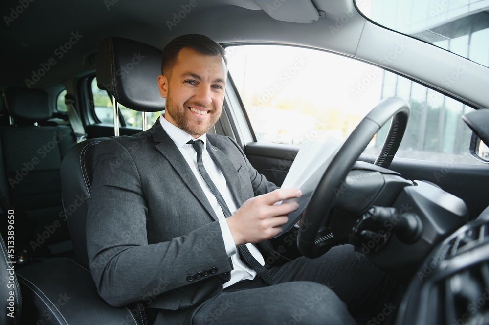Attractive elegant happy man in good car Attractive elegant happy man in good car