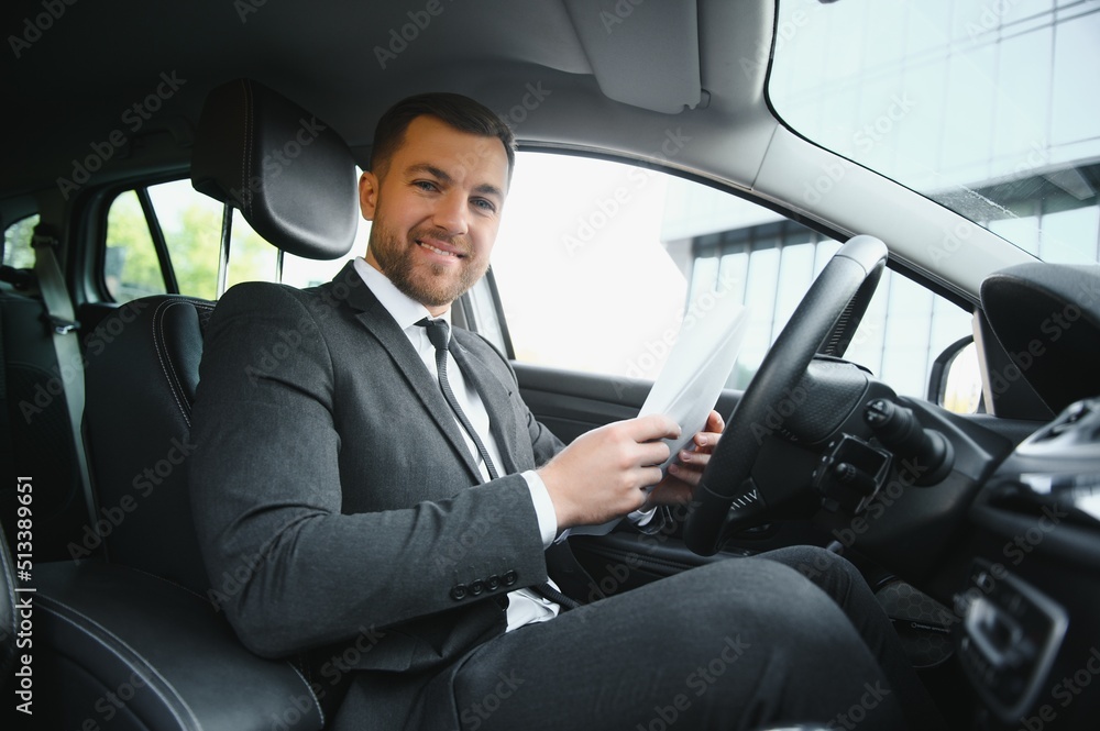 Attractive elegant happy man in good car Attractive elegant happy man in good car