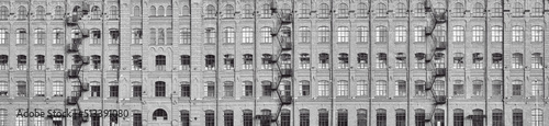 steel staircases and windows on old grey brick wall