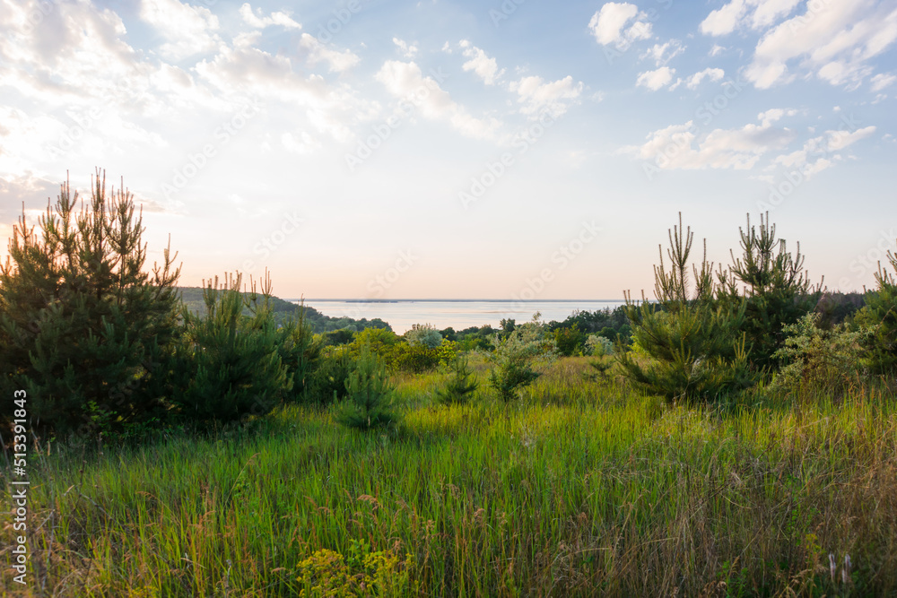 Sunset over the river. Beautiful sunset on the hills of the Dnipro river. Panoramic view of the Ukrainian landscape