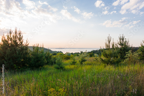 Sunset over the river. Beautiful sunset on the hills of the Dnipro river. Panoramic view of the Ukrainian landscape