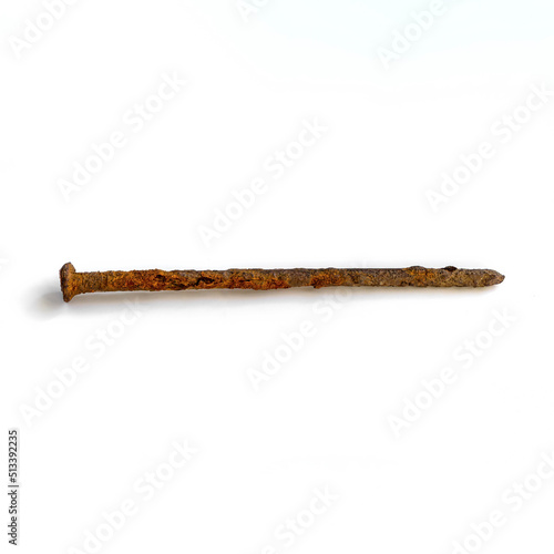 an old long rusted nail on a white background