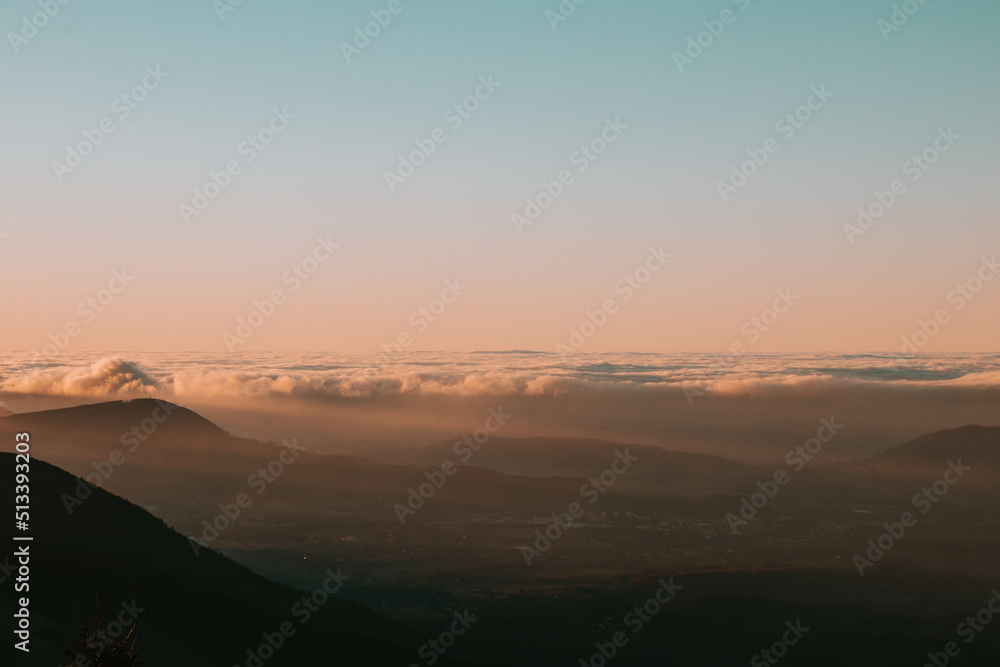 Obraz premium Sun's rays touch the mountains as the sun sets and a cloud storm approaches. Beskydy mountains under the light of the sky. Czech republic landscapes