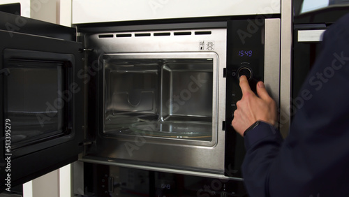 Close up of demonstrating the space inside the empty microwave oven. Household utensils. New model of a microwave, concept of technologies for home use.