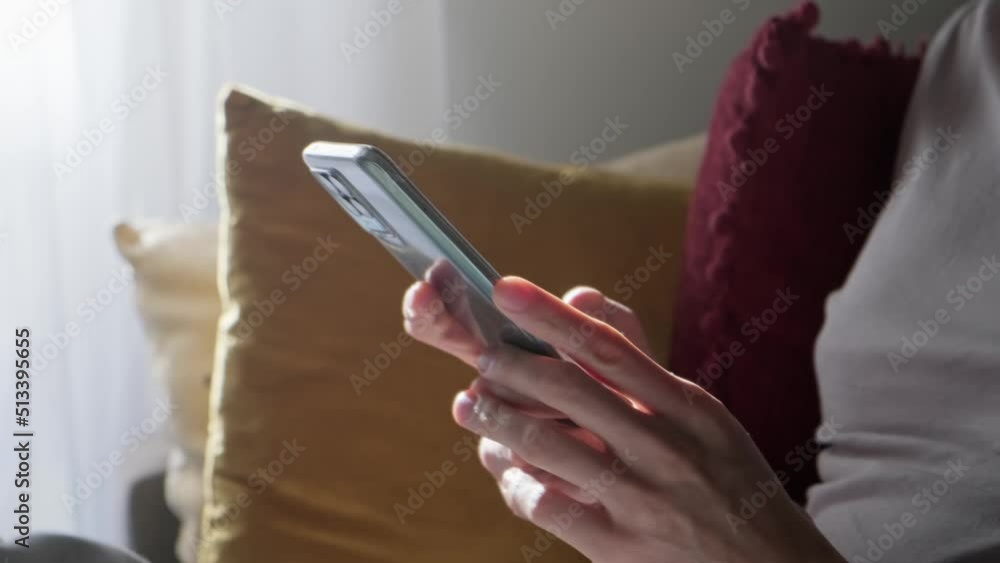 Man using smartphone at home, soft light. Man using smartphone at home, soft light.
