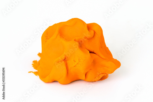 Orange colorful play dough for kids on white background. Children creativity and modeling clay photo