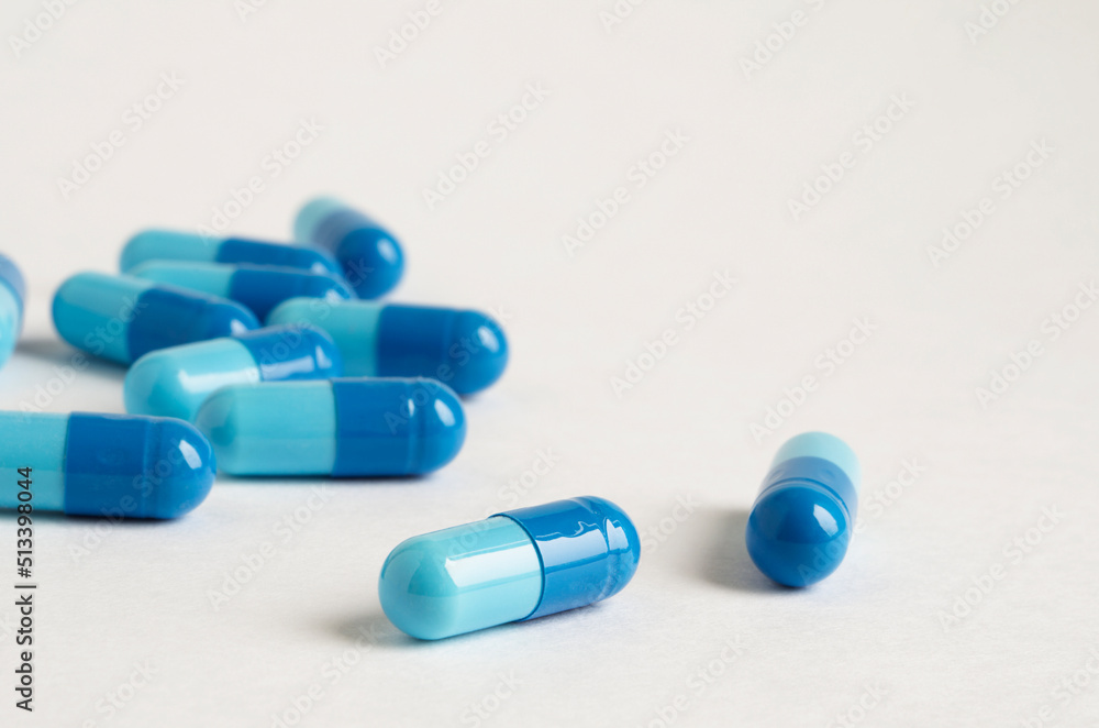 pills scattered on a white background