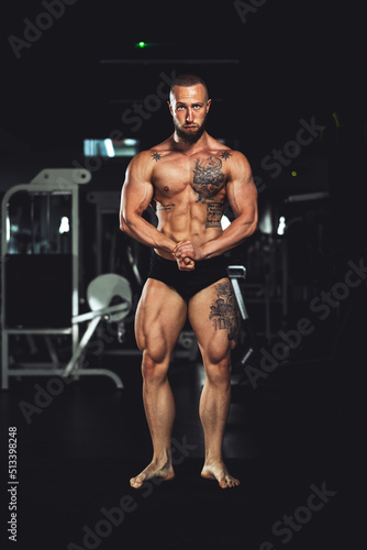 Fitness Man Showing His Muscles At The Gym