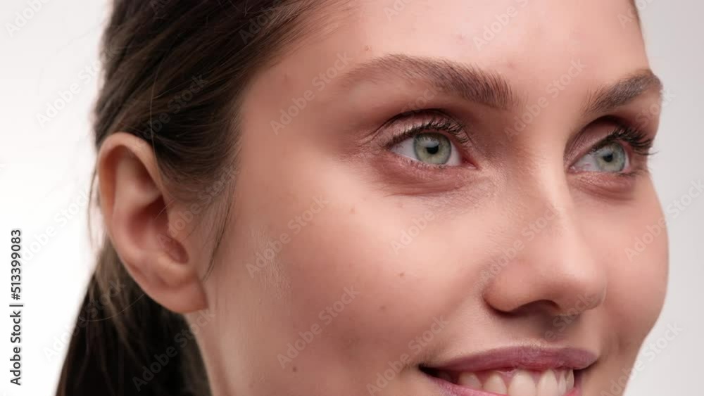 Beauty concept. Close up view. Brunette woman paints her eyebrows with eyebrow brush. Female makes makeup. Beauty treatment on white isolate background. 4k. Beauty concept. Close up view. Brunette woman paints her eyebrows with eyebrow brush. Female makes makeup. Beauty treatment on white isolate background. 4k.