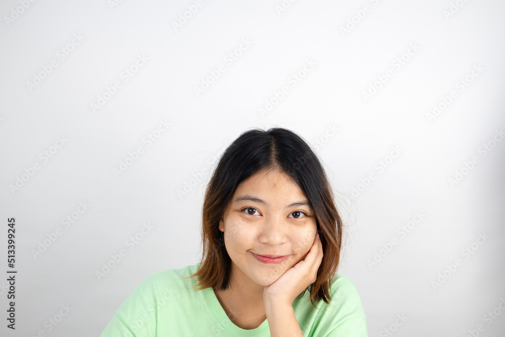 Smiling Asian woman looking at camera on white background. Smiling Asian woman looking at camera on white background.