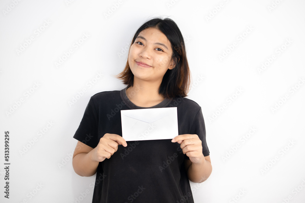 Asian girl wearing a black T-shirt holding an envelope on white background World Post day concept Asian girl wearing a black T-shirt holding an envelope on white background World Post day concept