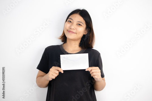 Asian girl wearing a black T-shirt holding an envelope on white background World Post day concept