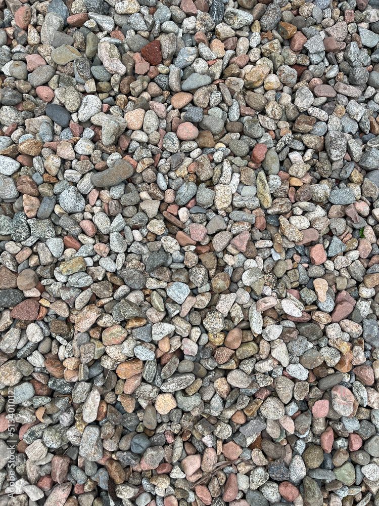 Naklejka premium Small stone texture for background. High quality photo. Rocks on a walk by the water.