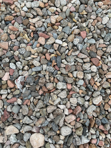 Small stone texture for background. High quality photo. Rocks on a walk by the water.