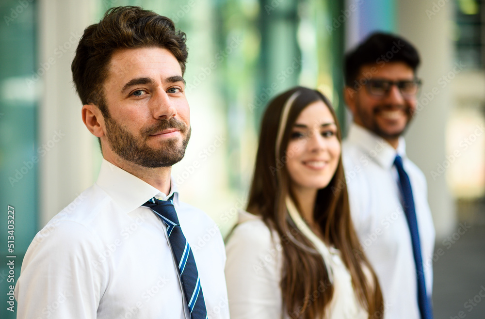 Business team smiling outdoor in a modern urban setting Business team smiling outdoor in a modern urban setting