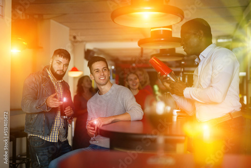 Group of male friends with alcohol in nightclub. High quality photo