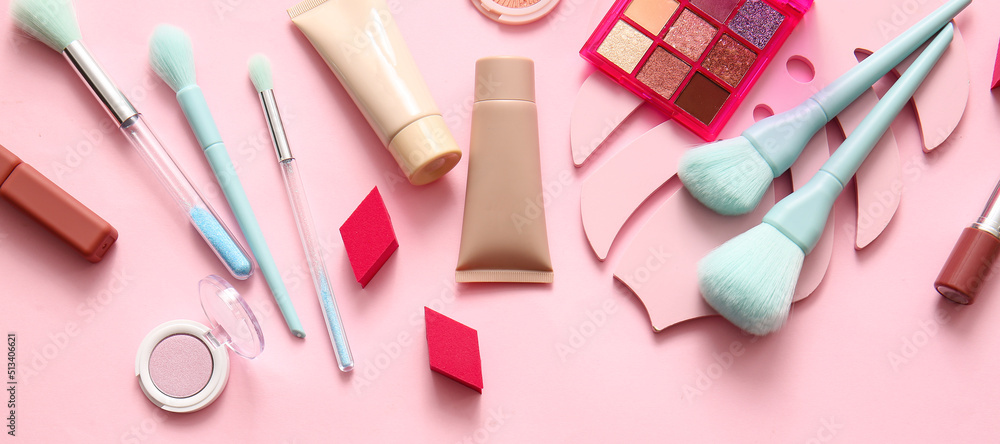 Set of decorative cosmetics and accessories on pink background, top view Set of decorative cosmetics and accessories on pink background, top view