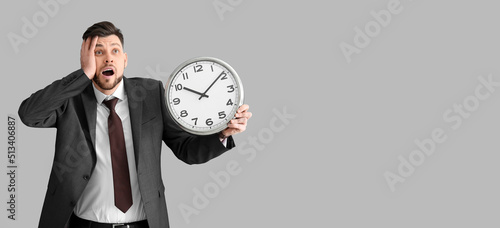 Stressed businessman holdin...