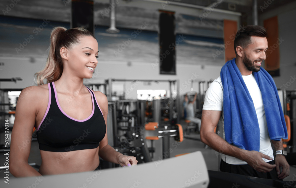 attractive sports couple talking in the gym attractive sports couple talking in the gym
