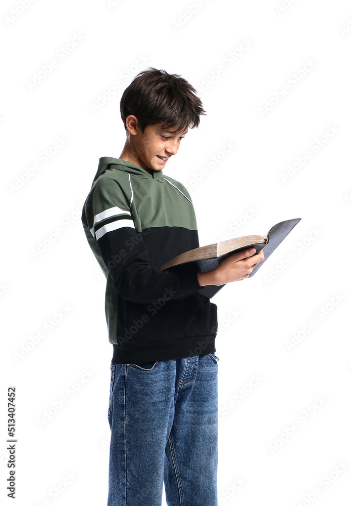 Teenage boy reading Holy Bible on white background Teenage boy reading Holy Bible on white background