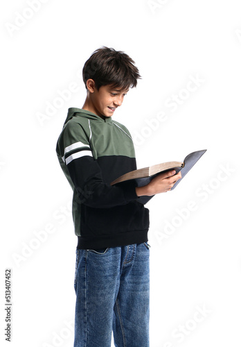 Teenage boy reading Holy Bible on white background