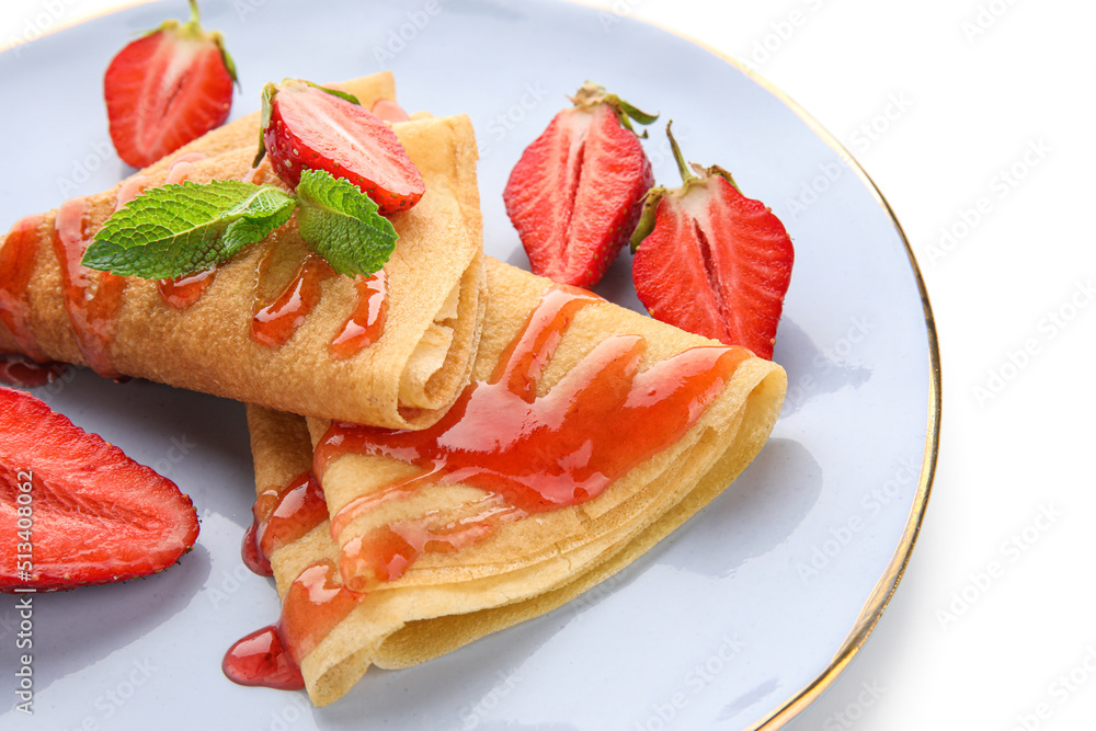 Plate of thin pancakes with strawberries and mint leaves on white background, closeup Plate of thin pancakes with strawberries and mint leaves on white background, closeup