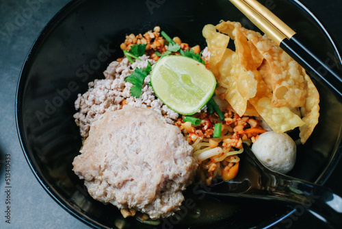 Spicy Tomyum Thai noodle soup with lemon, chilis,coriander, lemon grass. Thai noodle street food.