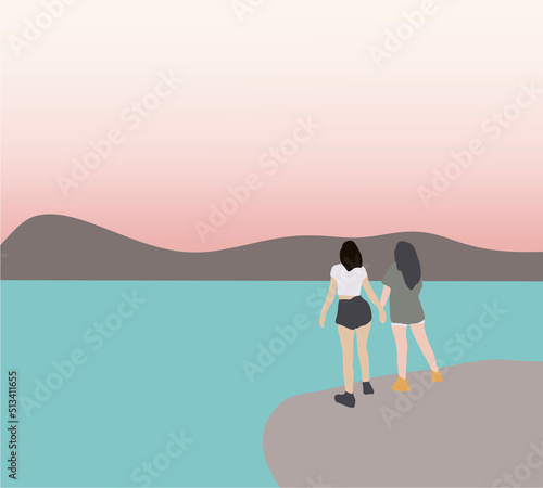 Lesbian couple looking mountain and lake watching the sunset. Healthy outdoor lifestyle, friendship and holiday vacation concept.
