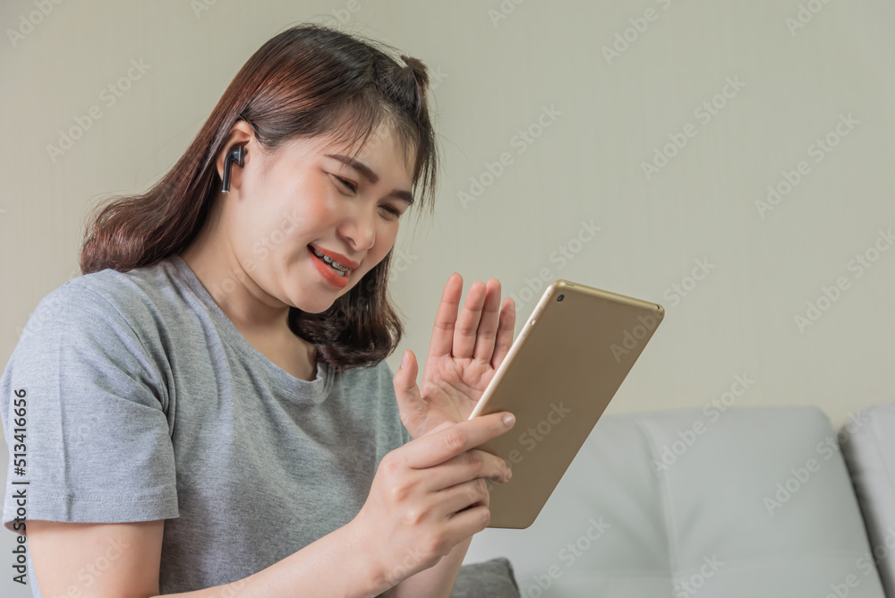 woman use tablet and ear phone watching social cam woman use tablet and ear phone watching social cam